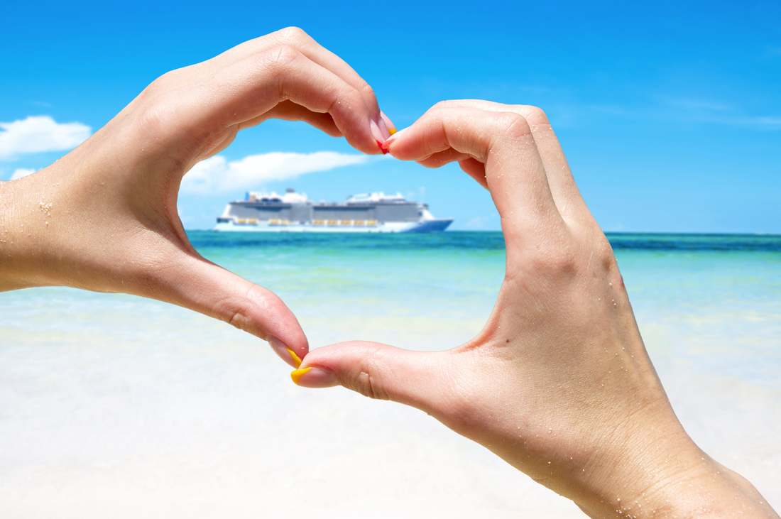 finger forming heart around cruise ship
